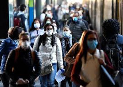 Masked and standing apart, the world tiptoes out of lockdown