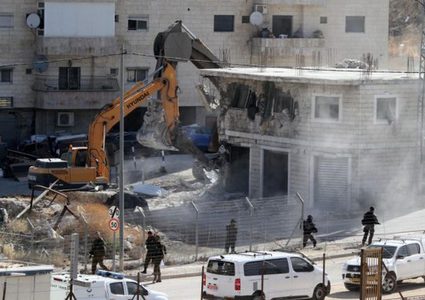 Israeli occupation demolishes a Palestinian building in the occupied Jerusalem