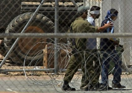 Two injured Palestinians among detainees in raids by IOF